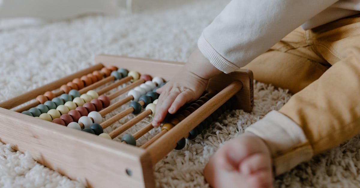 Toddler engaging with a wooden abacus on a fluffy carpet, promoting early learning.
