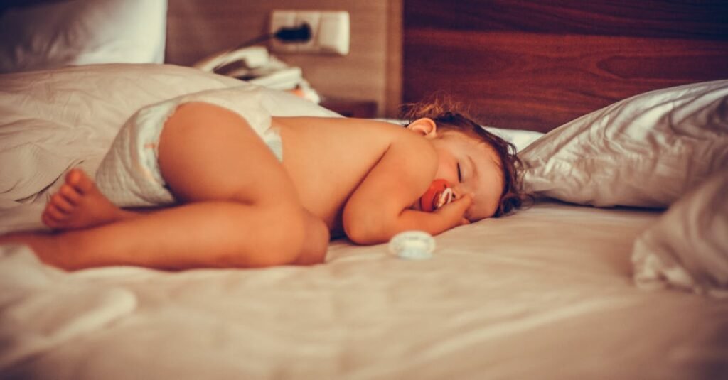 A serene image of a baby sleeping peacefully on a bed, conveying warmth and tranquility.